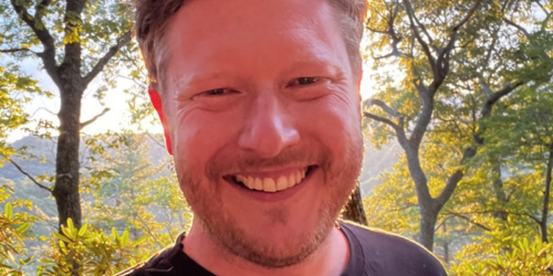 Dr Andy Flack headshot with trees in background